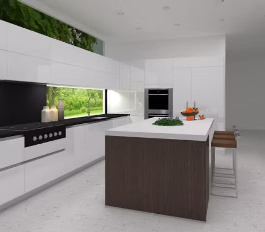 A bright renovated kitchen with handleless white cabinetry, a dark stone counter, a long window splashback looking onto greenery and a timber-clad island